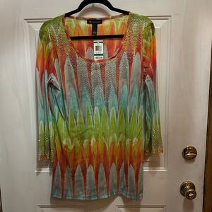 Beautiful colored tunic with sparkle embellishments at neckline and sleeve